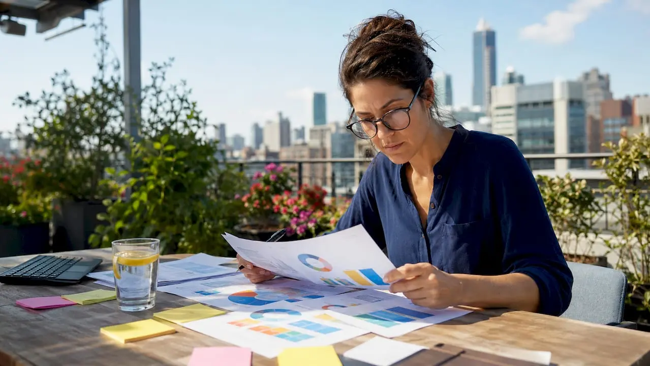 Marketing analyst reviewing printed SEO audit reports