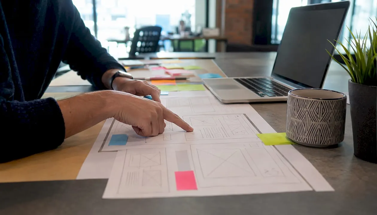 Hands pointing at website survey placement wireframe