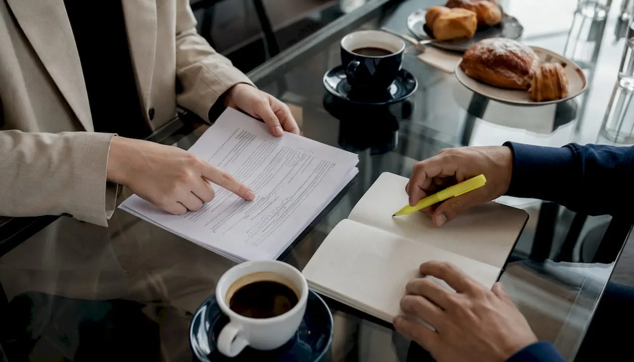 Hands pointing at code review sheets during mentorship