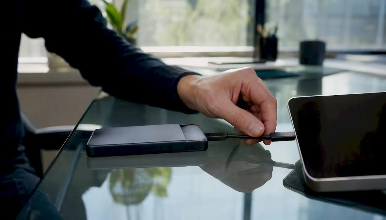 Hand plugging USB to external backup drive